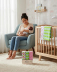 Stork And Baby Mothers Choice 3 pack floral cotton receiving blankets in a nursery with a mother holding her baby.
