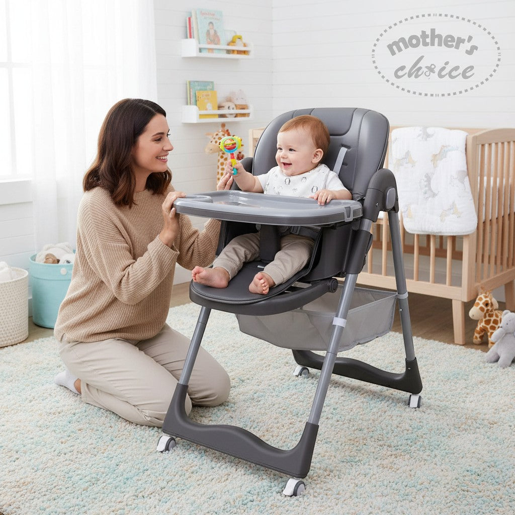 Mother's Choice grey folding baby high chair with a baby sitting in it and a woman kneeling beside it.
