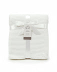 Stork And Baby Mothers Choice white 100% acrylic knit baby shawl, folded with a satin ribbon and product tag.