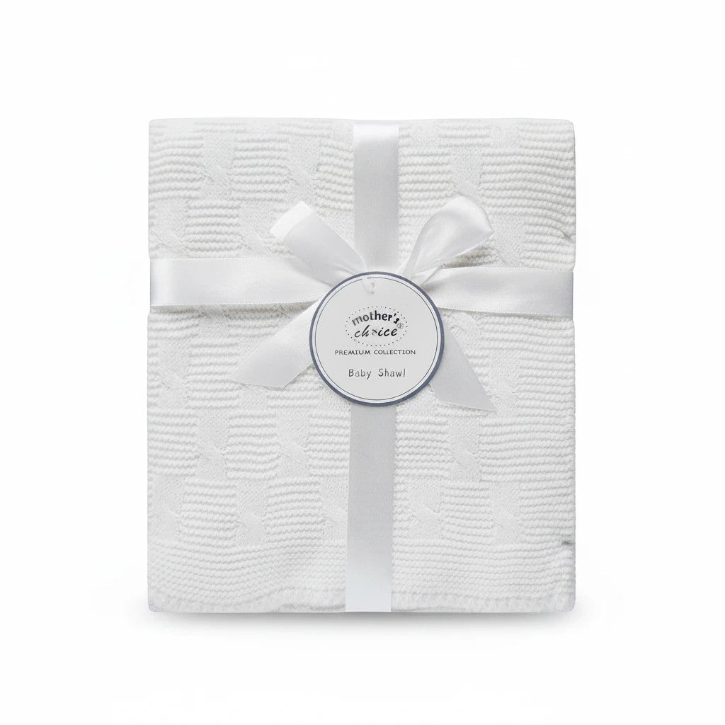 Stork And Baby Mothers Choice white knitted baby shawl with cable pattern, tied with a ribbon and gift tag.