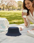 Stork And Baby navy blue round denim bucket hat with red stitching detail, perfect for babies.