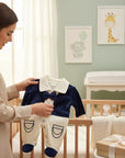 Stork And Baby navy blue and cream velvet baby romper with bowtie and collar detail. For ages 0-9 months.