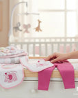 Stork And Baby 5-piece pink elephant baby gift set with bodysuit, pants, socks, bib, and cap. Soft cotton.