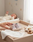 Stork And Baby pink and navy striped boat socks in gift box with baby in background