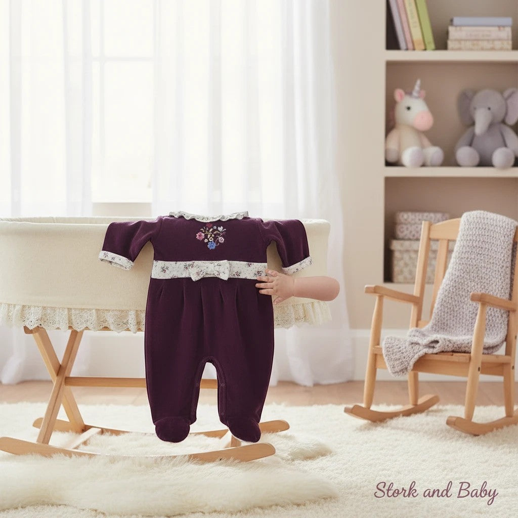 Stork and Baby plum velour baby grower with floral embroidery and white trim. Footed design.
