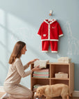 Stork And Baby red coral fleece tracksuit with "Love" detail, white trim, and hood. Cozy baby girl loungewear.
