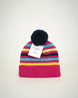 Stork And Baby striped knit winter hat with pom-pom. Pink, teal, yellow, and black stripes.