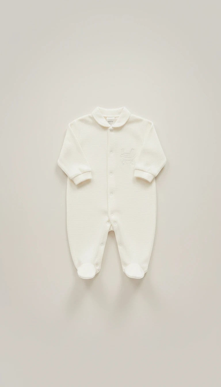 Stork And Baby white footed baby grow with silver embroidery detail on chest and collar. Cotton blend.
