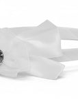 Stork And Baby Mothers Choice white girls alice band featuring a satin bow and a sparkling central diamante detail.