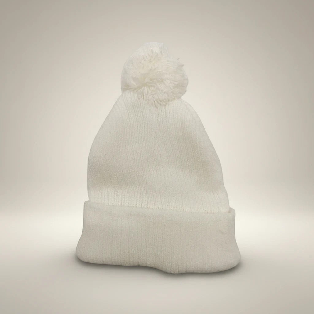 Stork And Baby white knit infant earflap hat with pom-pom, perfect for winter.