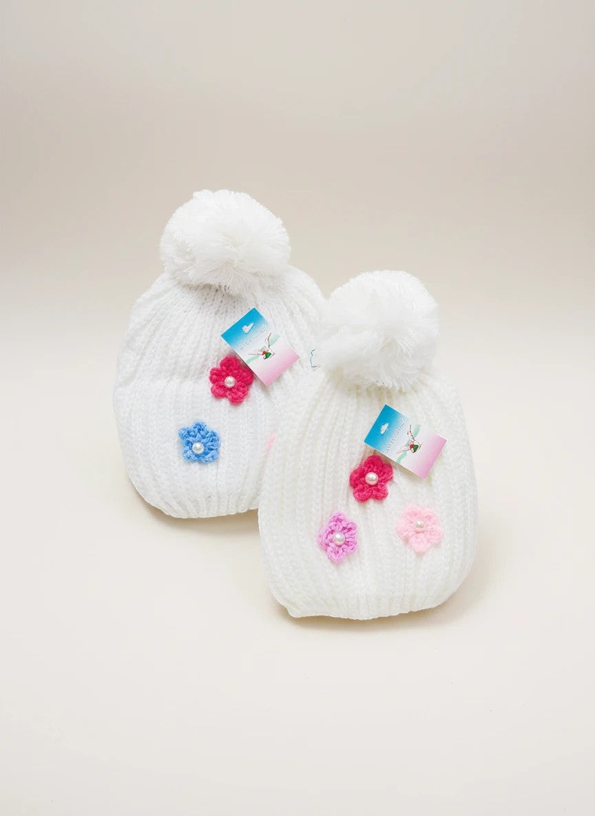 Stork And Baby white knit baby beanies with pom-poms and colorful flower appliques. 2 pack.