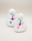 Stork And Baby white knit baby beanies with pom-poms and colorful flower appliques. 2 pack.